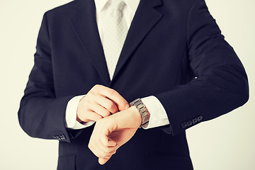 Image showing man looking at wristwatch