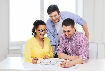 Image showing three smiling architects working in office