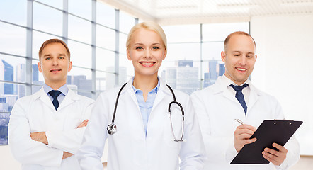 Image showing group of smiling doctors with clipboard