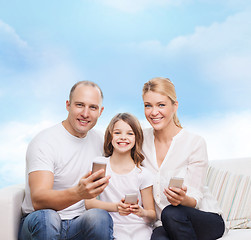 Image showing happy family with smartphones