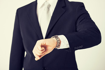 Image showing man looking at wristwatch