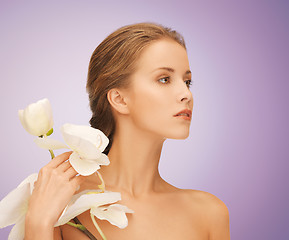 Image showing beautiful young woman with orchid flowers