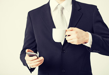 Image showing man with smartphone and cup of coffee