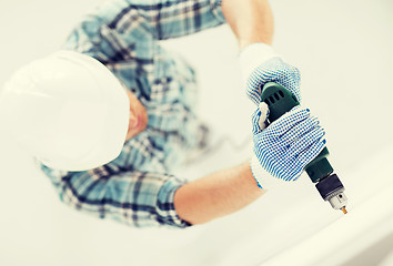 Image showing man drilling the wall