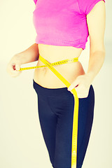 Image showing trained belly with measuring tape
