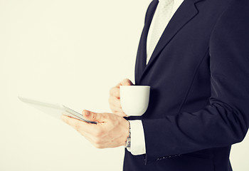 Image showing man with tablet pc and cup of coffee