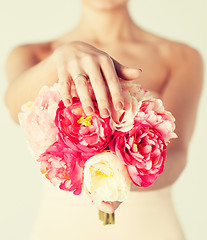 Image showing bride with bouquet of flowers and wedding ring