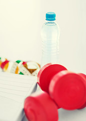 Image showing scales, dumbbells, bottle of water, measuring tape