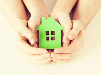 Image showing couple hands holding green house