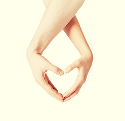 Image showing woman and man hands showing heart shape