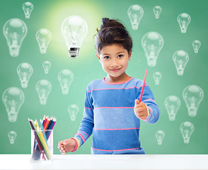 Image showing happy school girl drawing with coloring pencils