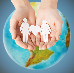 Image showing female hands with paper gay couple figures