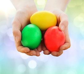 Image showing close up of kid hands holding colored eggs