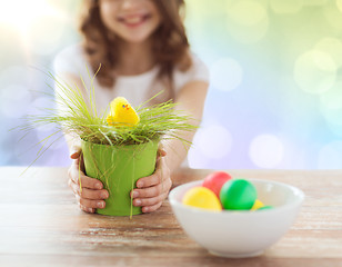 Image showing close up of girl holding pot with easter grass