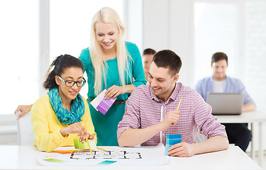 Image showing smiling interior designers working in office