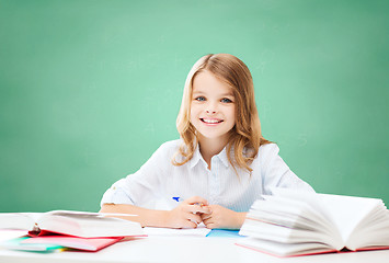 Image showing happy girl with books and notebook at school