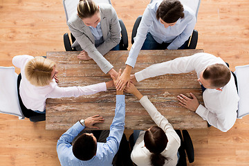 Image showing close up of business team with hands on top