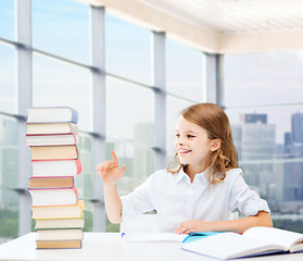 Image showing happy girl with books and notebook at school