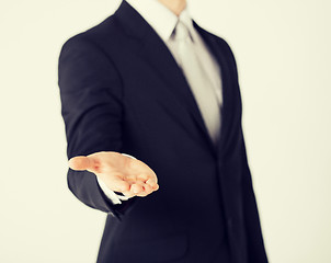 Image showing mans hand showing something