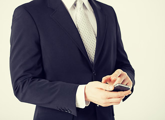 Image showing man with smartphone typing something