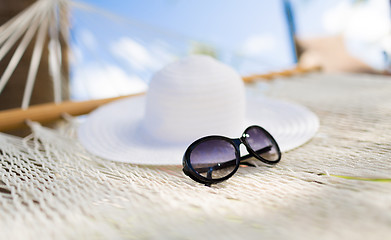 Image showing picture of hammock with white hat and sunglasses