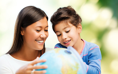 Image showing happy mother and daughter with globe