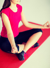 Image showing girl sitting in lotus position and meditating
