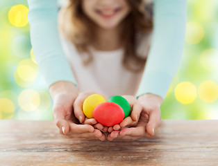 Image showing close up of happy family holding easter eggs