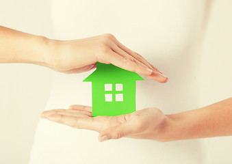 Image showing woman hands holding green house