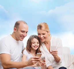 Image showing happy family with smartphones