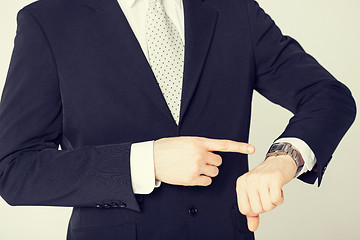 Image showing man looking at wristwatch