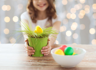 Image showing close up of girl holding pot with easter grass