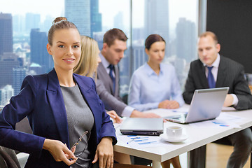 Image showing businesswoman over business team in office