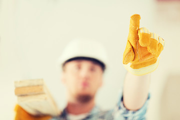 Image showing close up of male in gloves carrying wooden boards