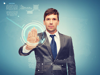 Image showing attractive buisnessman working with virtual screen