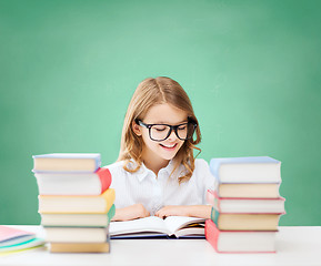 Image showing happy student girl reading book at school