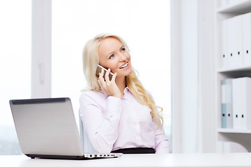 Image showing smiling businesswoman calling on smartphone