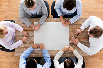 Image showing close up of business team sitting at table