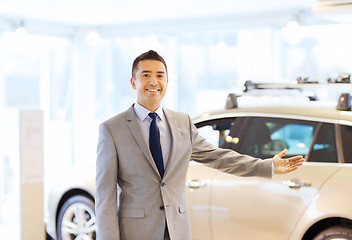 Image showing happy man at auto show or car salon