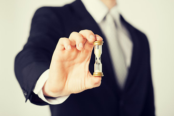 Image showing man hand holding hourglass