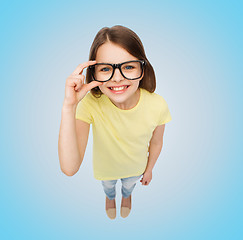 Image showing smiling little girl in black eyeglasses