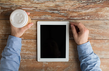 Image showing close up of male hands with tablet pc and coffee