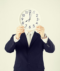 Image showing man with wall clock