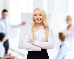 Image showing smiling businesswoman or secretary in office