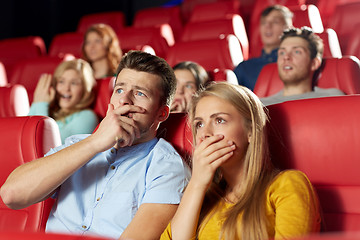 Image showing happy friends watching horror movie in theater