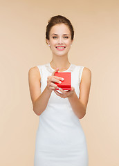 Image showing smiling woman holding red gift box