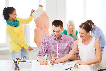 Image showing smiling fashion designers working in office