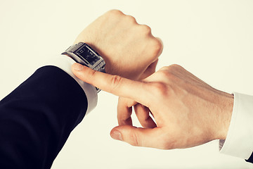 Image showing man looking at wristwatch