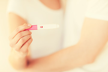 Image showing woman and man hands with pregnancy test