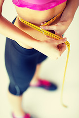 Image showing trained belly with measuring tape